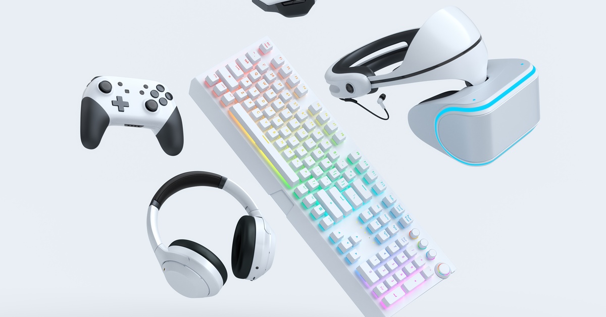 Pieces of gaming gear floating in a white space. There is a keyboard, controller, headphones, and a VR headset.